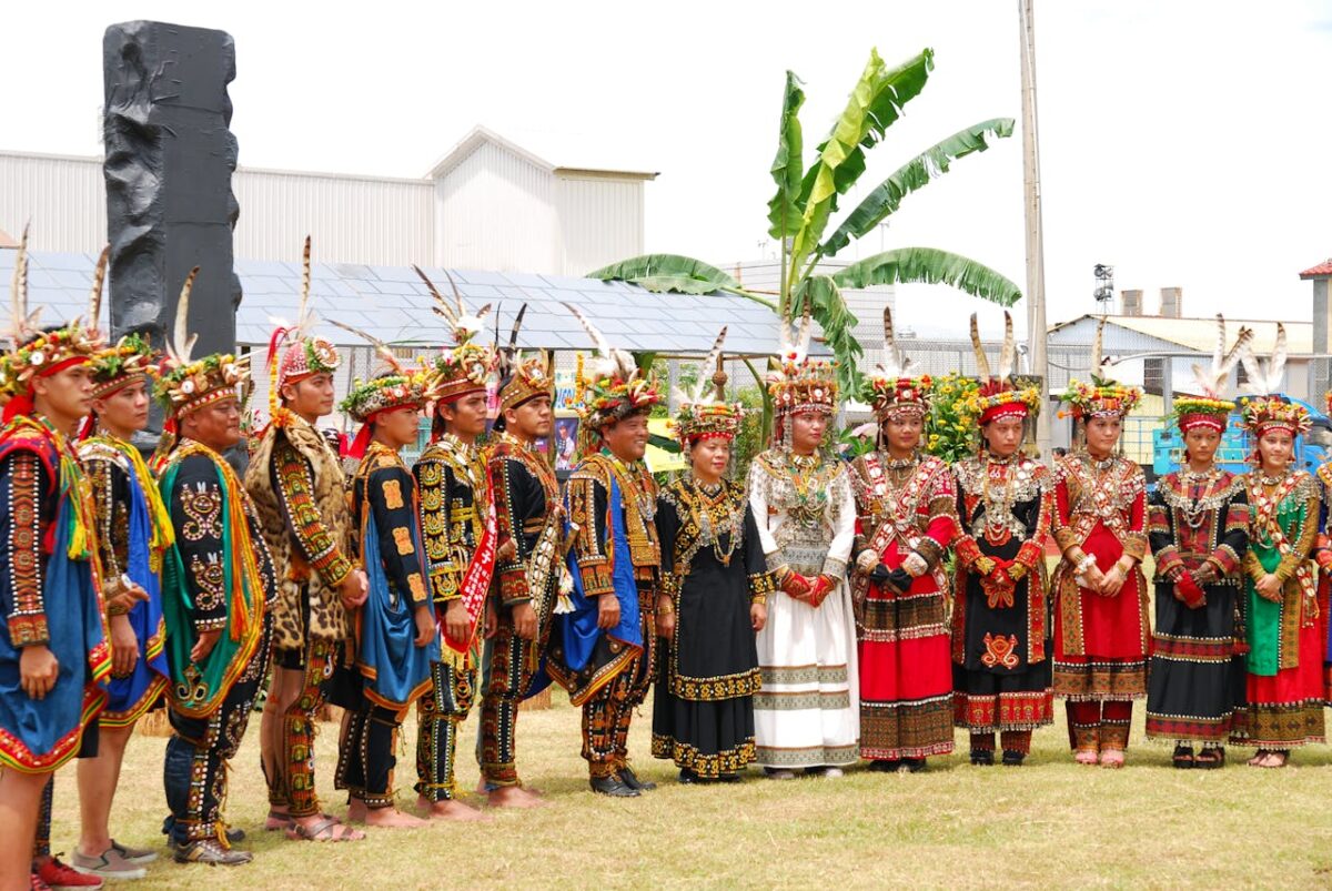 A vibrant display of traditional clothing in a cultural heritage ceremony outdoors.